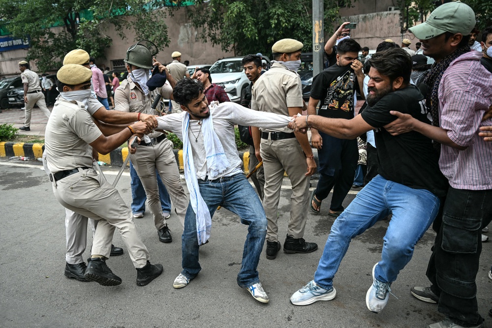 Activists and supporters of the Cockroach Janta Party clash with police during a protest in Delhi (AFP/Getty)