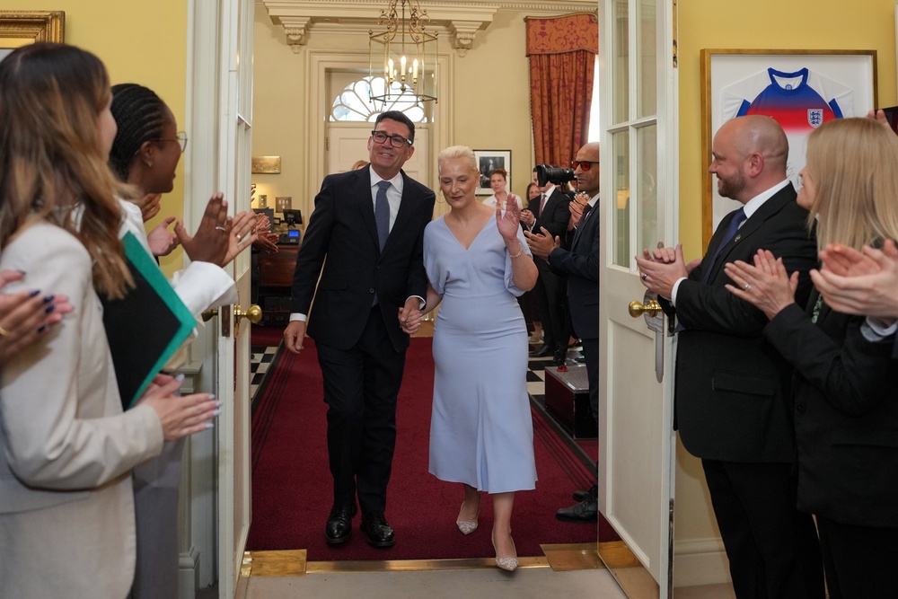 New Prime Minister Andy Burnham and his wife Marie-France van Heel are greeted by staff as he walks into 10 Downing Street, London, for the first time as Prime Minister (Kin Cheung/PA) (PA Wire)