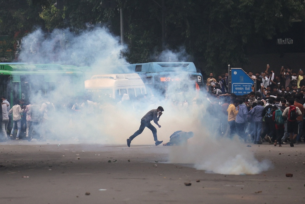 Tear gas spreads around protesters (Reuters)