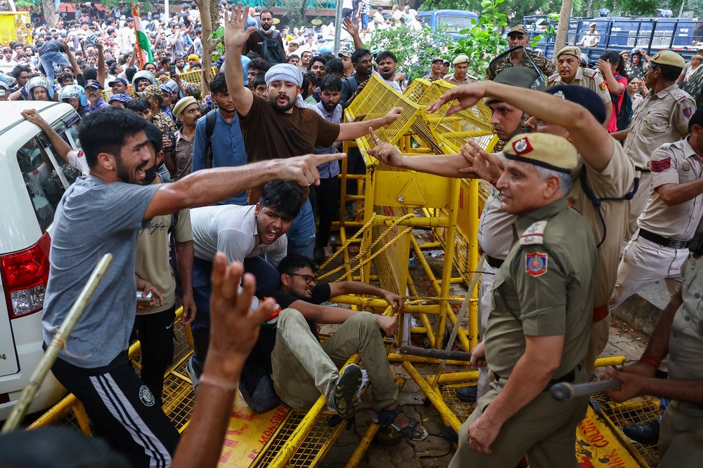 Protesters scuffle with police officers (Reuters)