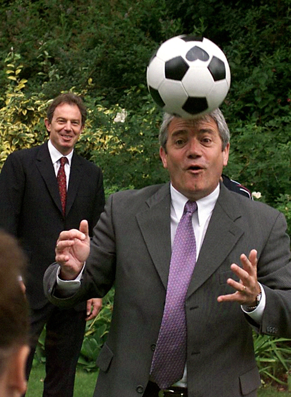 Then-England football manager Kevin Keegan heads a ball as Tony Blair watches in the back garden of 10 Downing Street (Sean Dempsey/PA) (PA Archive)