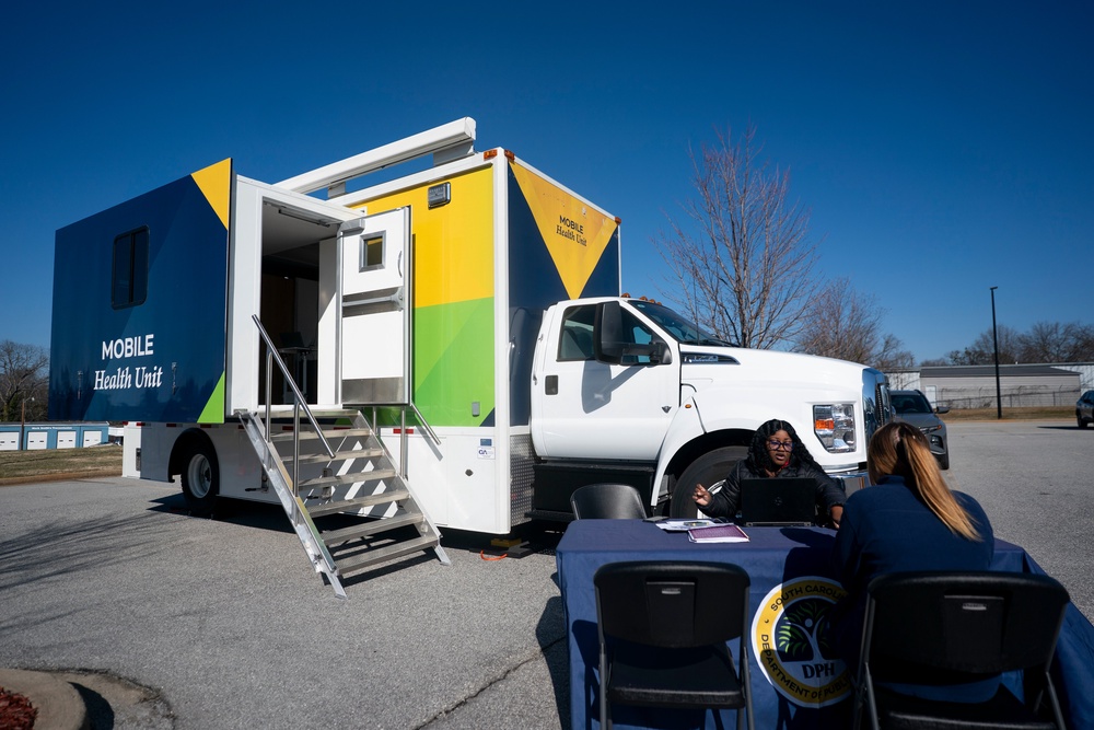 A worker with the South Carolina Department of Public Health talks to a patient outside a mobile vaccination clinic in February in Spartanburg, South Carolina. The state’s outbreak has ended (Getty)