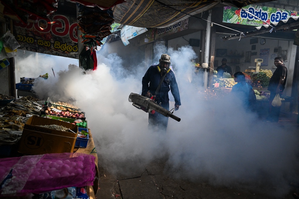 A municipal worker fumigates a market area during a dengue prevention campaign in Colombo on 15 July 2026 (AFP/Getty)