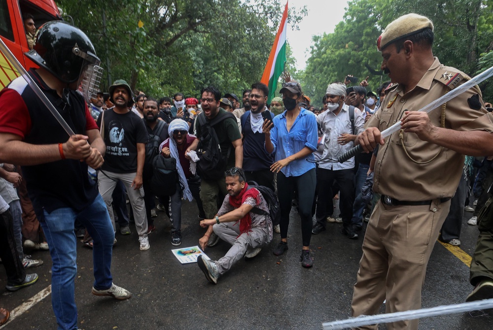 Police officers armed with batons confront protesters during a demonstration organised by the Cockroach Janta Party in Delhi on 20 July 2026 (Getty)