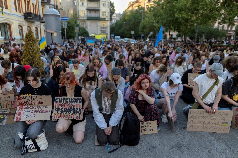 People observe a minute of silence during a protest demanding the reinstatement of Mykhailo Fedorov as defence minister and calling for the resignation of Commander in Chief of the Ukrainian Armed Forces Oleksandr Syrskyi (Reuters)