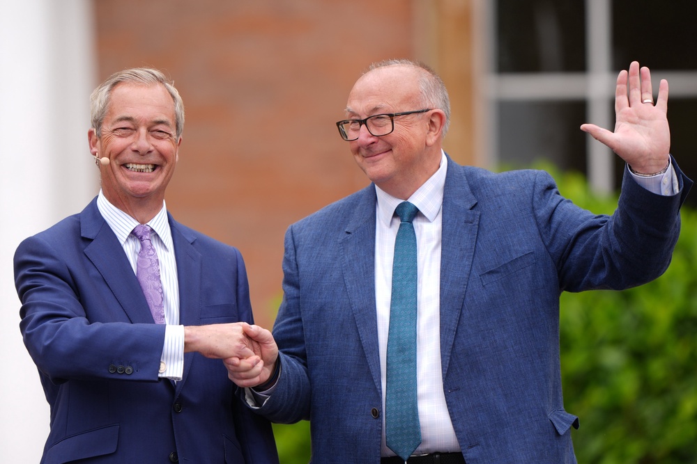 Sutton, right, pictured with Nigel Farage in July (PA)