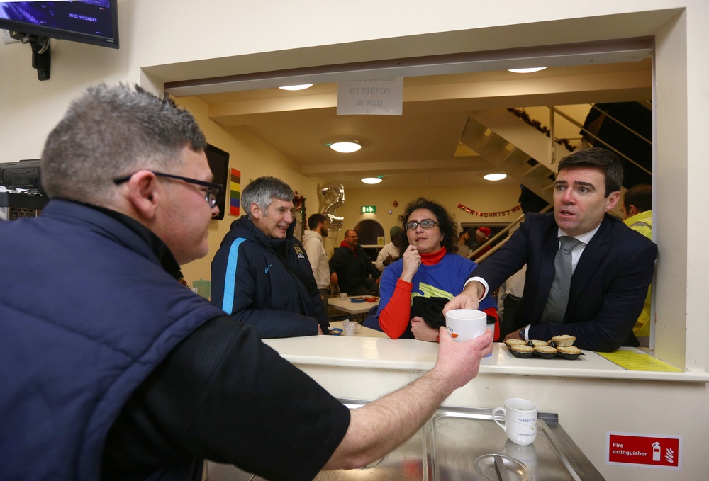 Mr Burnham, right, during a visit to the Barnabus Centre in Manchester in 2016 (Getty)