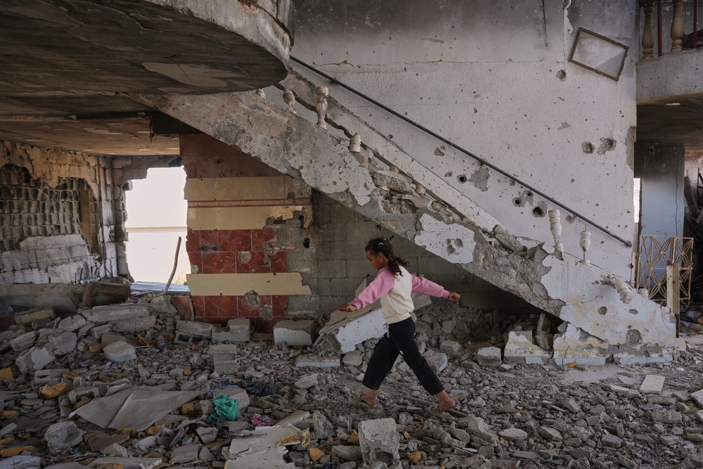 Arjwan al-Gharam walks over debris inside her home after it was damaged during the Israel-Hamas war in Nuseirat, central Gaza Strip, Thursday, June 4, 2026. (AP Photo) (Copyright 2026 The Associated Press. All rights reserved.)