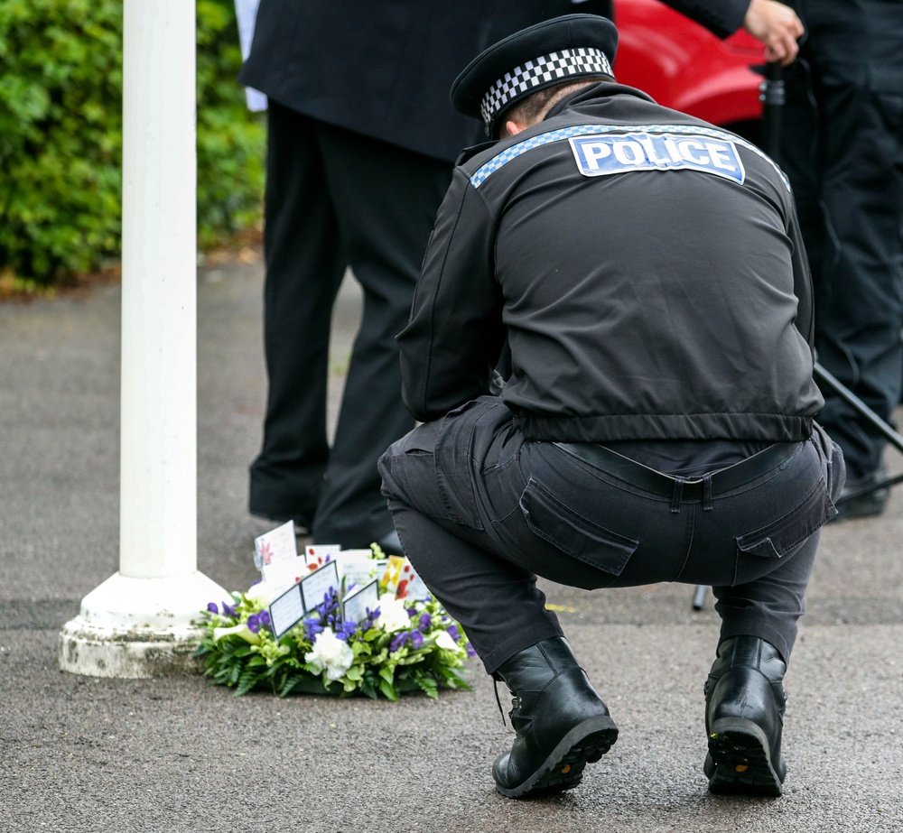 A Thames Valley Police officer looks at a floral tribute at the end of a memorial service for Pc Andrew Harper (Steve Parsons/PA) (PA Archive)