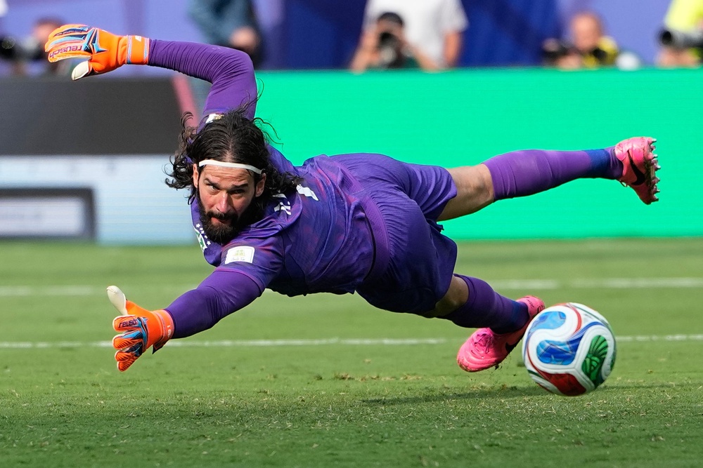 Alisson is someone Iraola wants to keep at Anfield (AP)