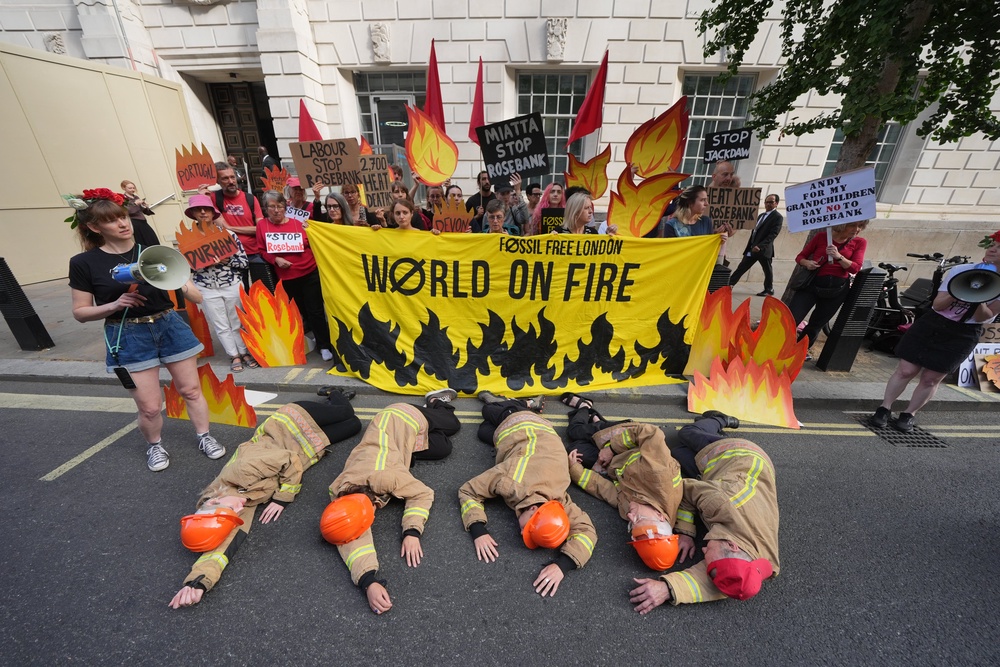Campaigners dressed as firefighters (Yui Mok/PA) (PA Wire)