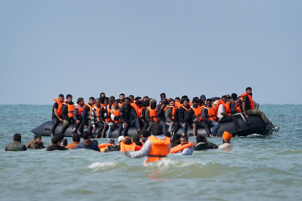 People thought to be migrants board a small boat off the coast of Equihen-Plage, France, during an attempt to cross the English Channel in July. (PA Wire)