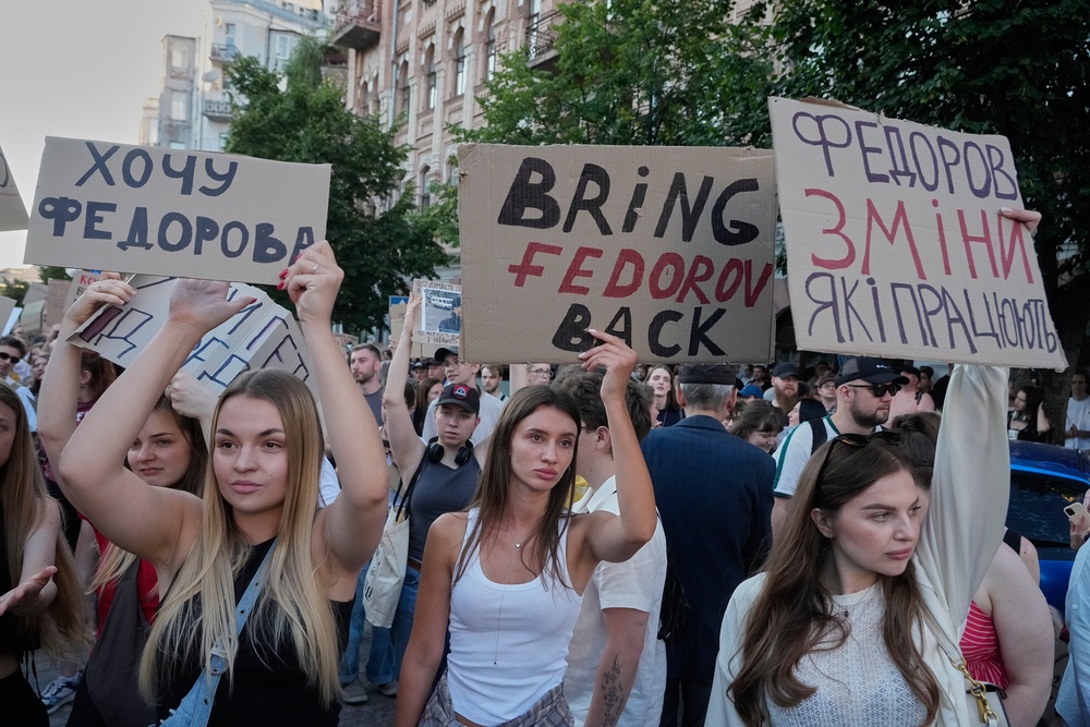 Activists shout slogans during a rally to denounce President Volodymyr Zelensky's decision to dismiss Defense Minister Mykhailo Fedorov after six months in the post, Friday, July 17 (AP)