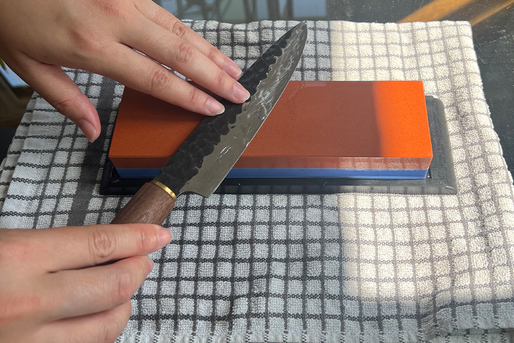 You need to keep the stone wet at all times while sharpening (Kate Ng/The Independent)