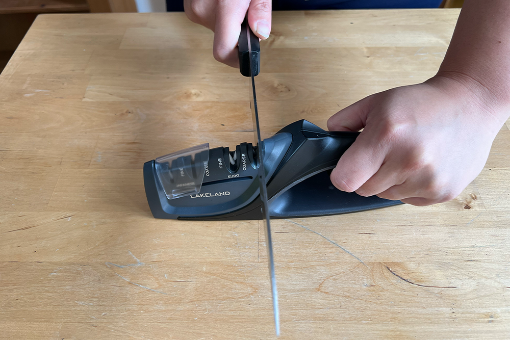 It is fairly lightweight but not so light that it won’t stay on a counter while sharpening knifes (Kate Ng/The Independent)