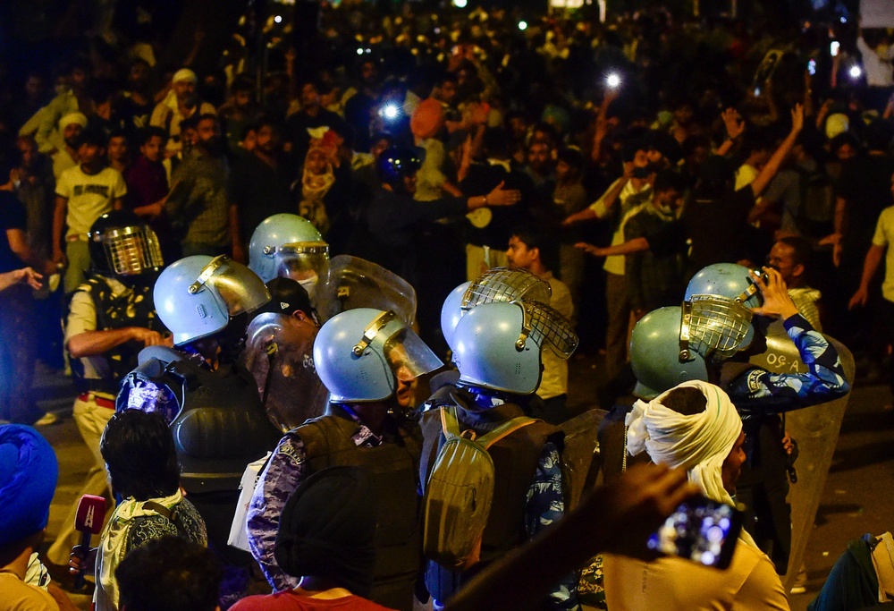Police officers in riot gear face protesters during a demonstration led by the Cockroach Janta Party (CJP) near Parliament Street on 22 July 2026 (Getty)