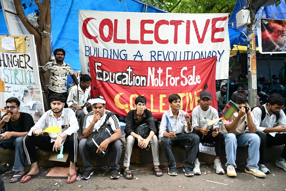 Cockroach Janta Party (CJP) supporters sit at Jantar Mantar in New Delhi on 23 July 2026 during the ongoing protest (AFP/Getty)