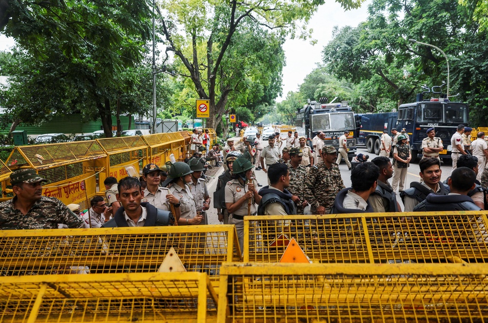Police personnel stand guard outside Minister of Education of India Dharmendra Pradhan's residence, as supporters of India's Cockroach Janata Party (CJP) demonstrate during the ongoing protests (Reuters)