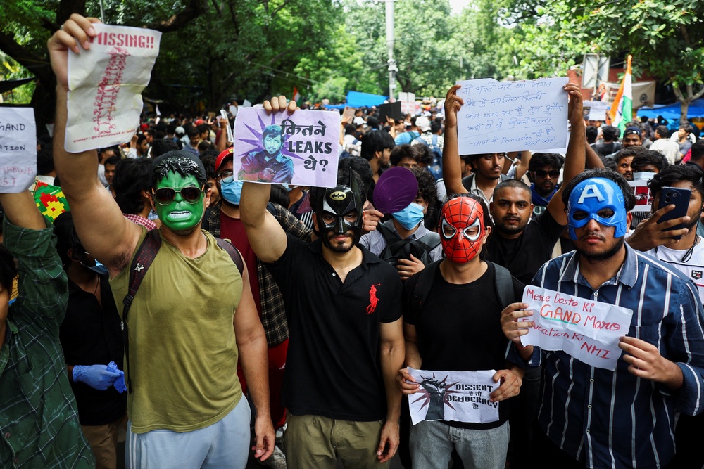 Supporters of India's Cockroach Janata Party (CJP) wearing masks, hold placards and chant slogans during ongoing protests (Reuters)