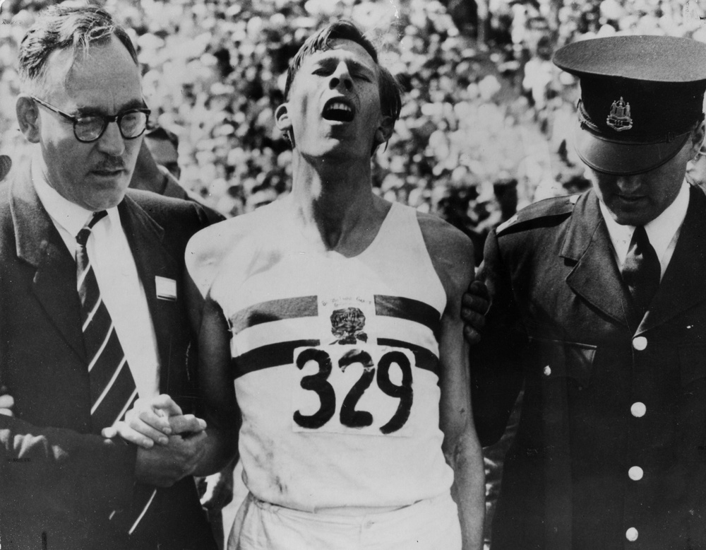 An exhausted Roger Bannister after beating John Landy in the Miracle Mile (Getty)