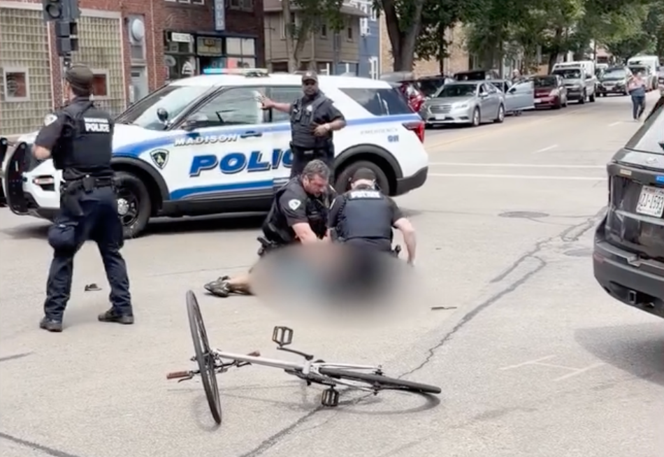 With the victim face down on the ground as blood poured from his head, the officer then placed the man’s hands behind his back. Another officer removed the knife (Michael Doubek)