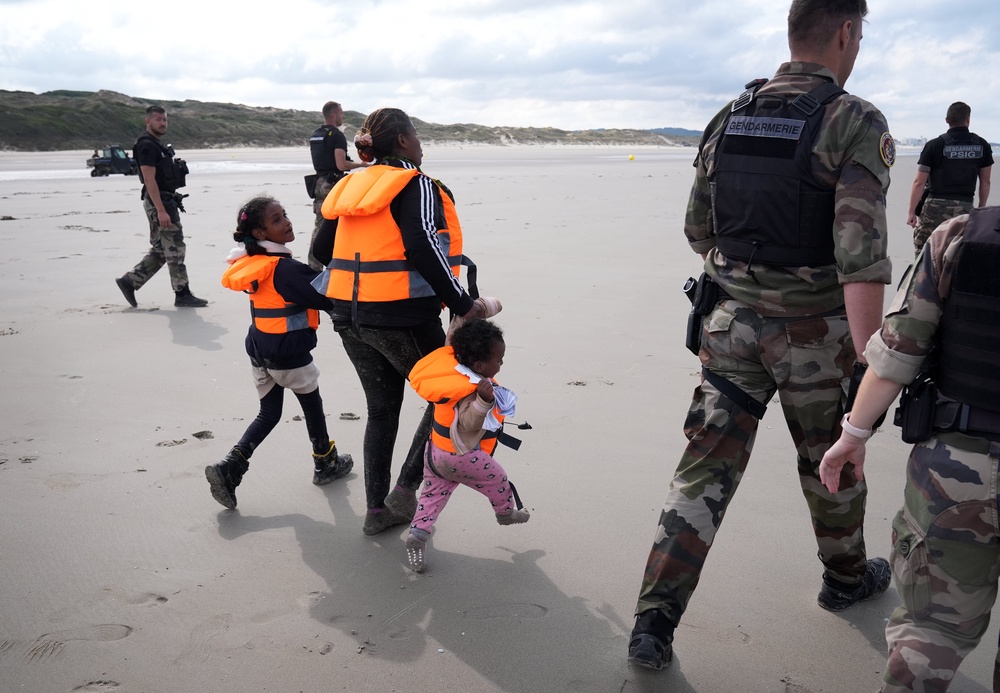 A woman with a young family is prevented from entering the sea on Wednesday at Equihen-Plage, France (Gareth Fuller/PA) (PA Wire)