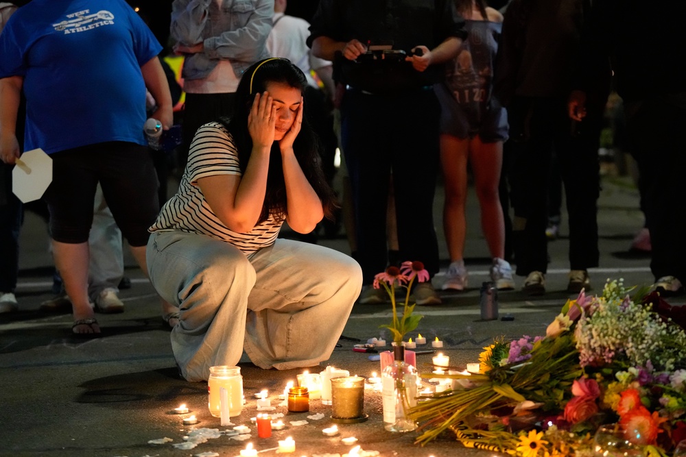 Hundreds of people took to the streets Wednesday evening to protest the killing and to hold a candlelight vigil in memory of the victim (AP)