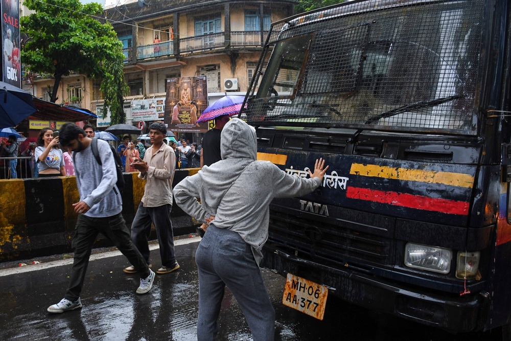 Rhiya Ahir, a model, blocks a police van carrying detained protesters during Cockroach Janta Party's ongoing protest movement in Mumbai ((AP Photo/Ashish Vaishnav))
