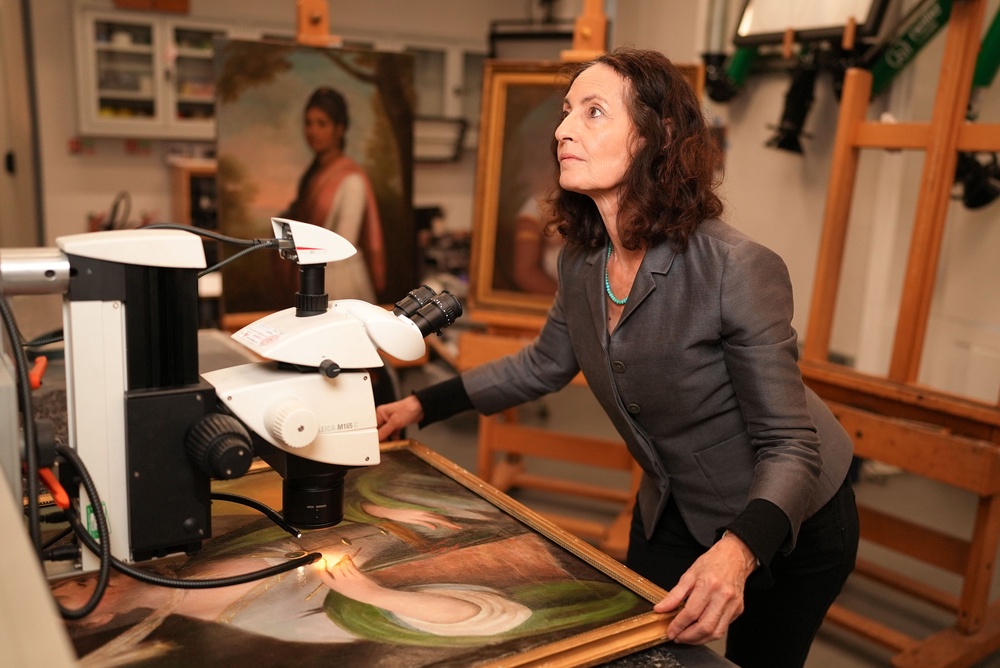 Professor Aviva Burnstock examines the painting (Philip Broadhurst/BBC/PA) (PA Media)