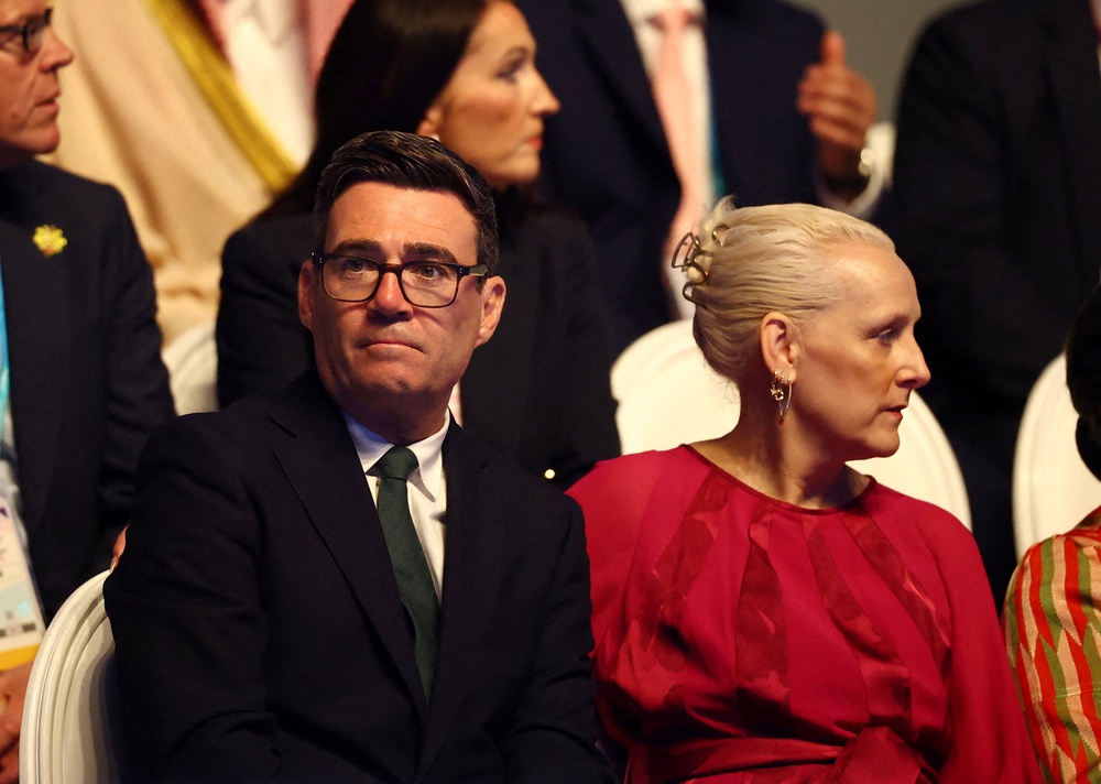 Andy Burnham at the Commonwealth Games with wife Marie-France van Heel (Reuters)