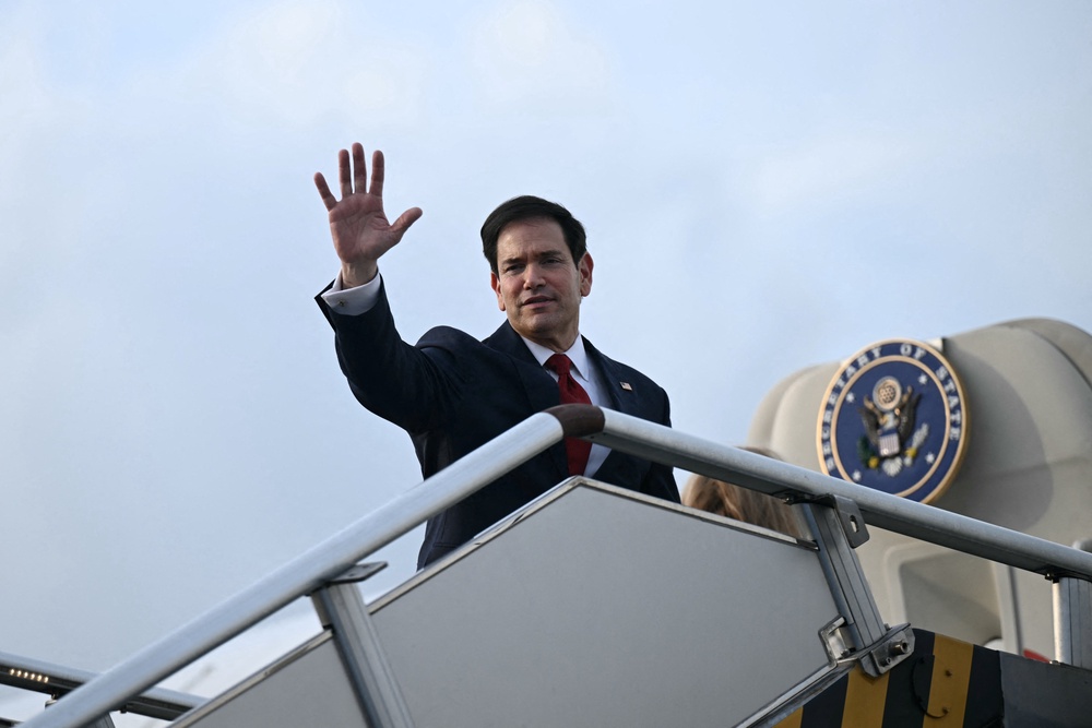 US Secretary of State Marco Rubio waves from the top of the steps to his plane as he departs at Ninoy Aquino International Airport in Metro Manila (Reuters)