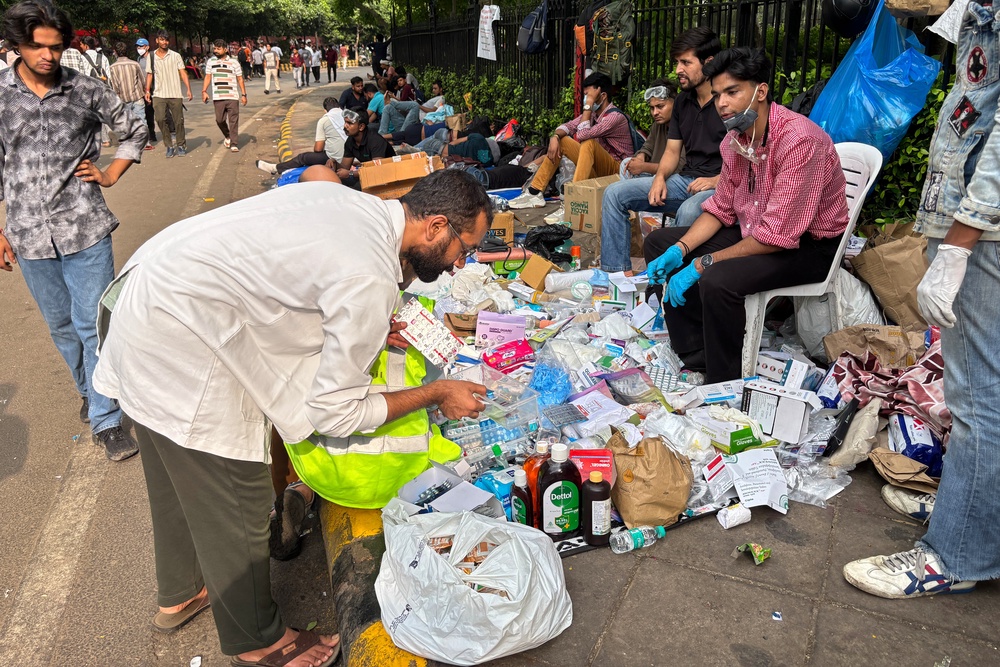 A volunteer doctor sorts strips of medicine at a makeshift stall set up for the protestors during a demonstration demanding educational reforms as part of the Cockroach Janta Party's ongoing protest movement in New Delhi, India (AP)