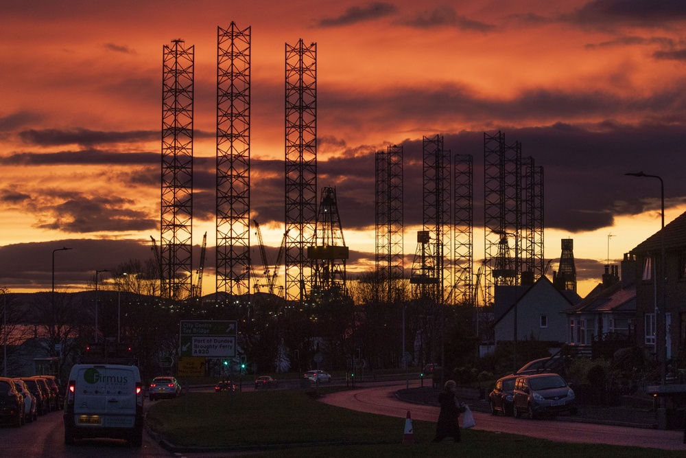 Jackup rigs, used in the North Sea oil and gas industry, are silhouetted against the sky at sunset over the Port of Dundee in the Firth of Tay, Dundee (Jane Barlow/PA) (PA Archive)