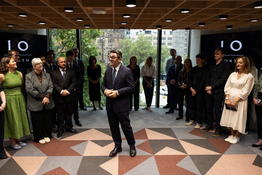 Britain's Prime Minister Andy Burnham speaks to staff members during a visit to officially open No10 North in Manchester (AFP/Getty)