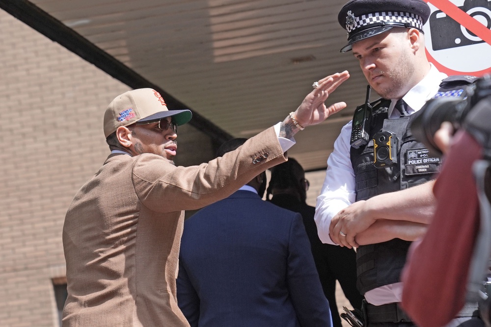 R&B singer Chris Brown waved to fans as he arrived at Southwark Crown Court (PA Wire)