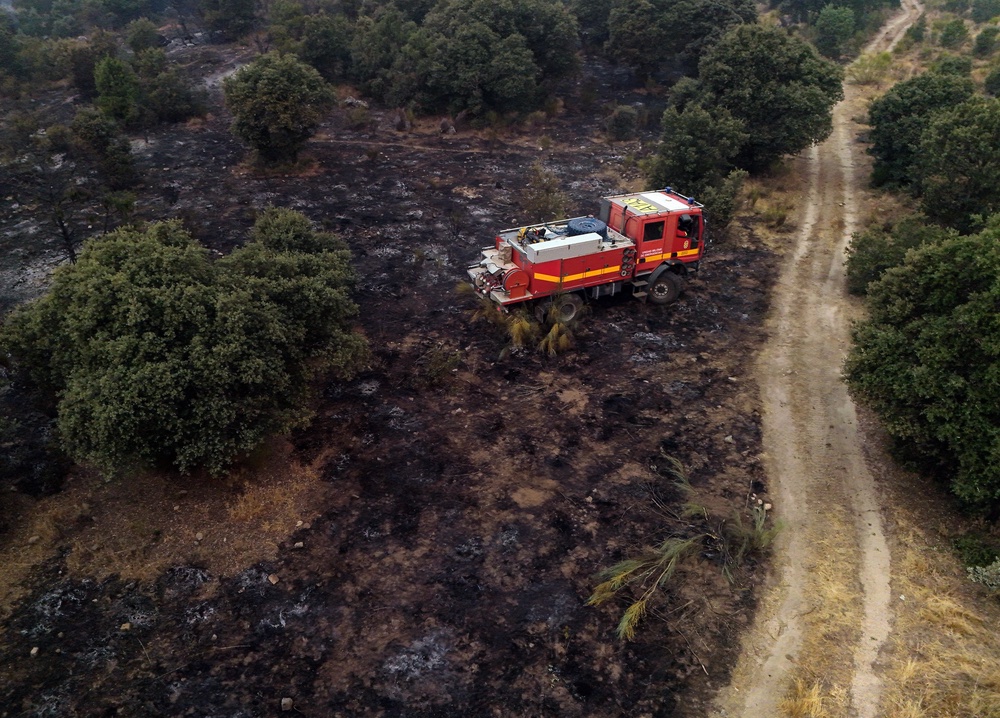 A fire truck in a burnt landscape near El Escorial (AFP/Getty)