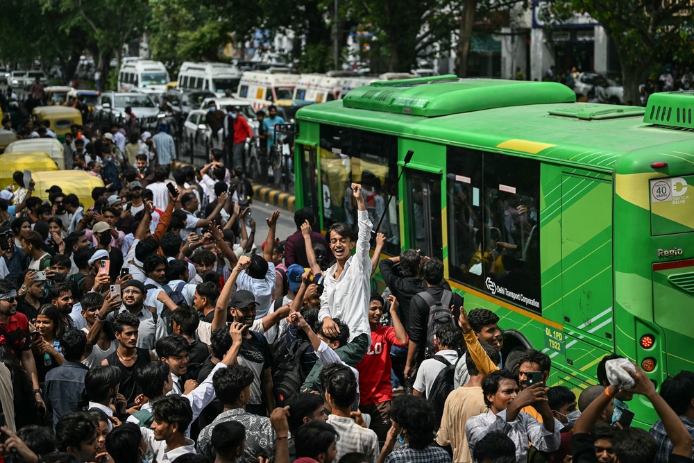 Cockroach Janta Party (CJP) supporters celebrate the resignation of India’s education minister Dharmendra Pradhan, at Jantar Mantar in New Delhi (AFP/Getty)