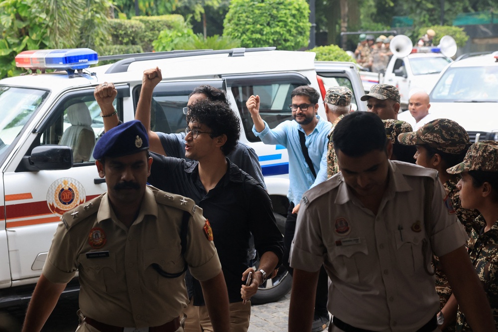 Saurav Das and Ashutosh Ranka, spokespersons from Cockroach Janta Party (CJP) arrive at constitution club to hold talks with JP Nadda, India’s senior federal ministers, after India’s Education Minister Dharmendra Pradhan resigned (Reuters)