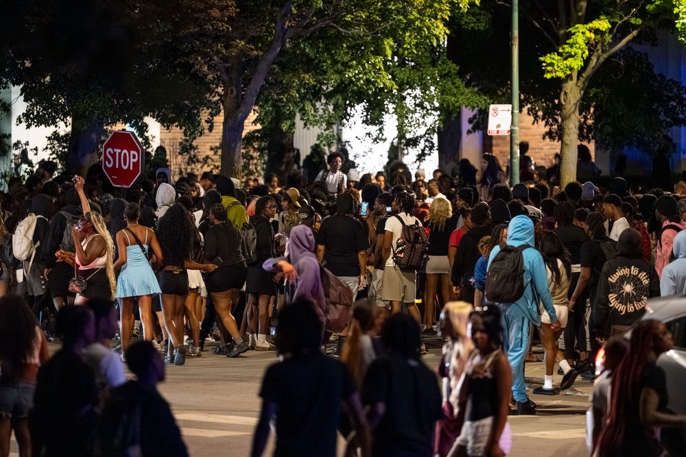Hundreds of young people gather near the Griffin Museum of Science and Industry in the Hyde Park neighborhood as Chicago police officers attempt to disperse them in May 2025 (Chicago Sun-Times 2026)