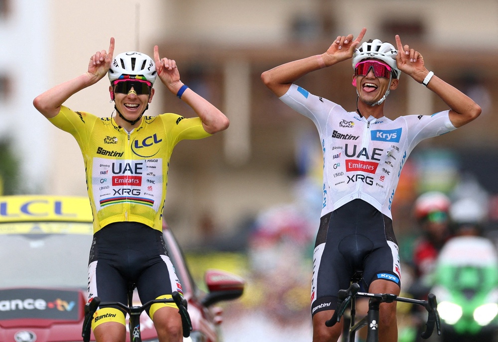 Tadej Pogacar crosses the finish line of stage 20 with teammate Isaac Del Toro (Reuters)