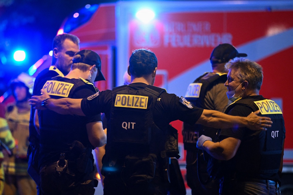 Police officers at the site, after the annual Berlin's Christopher Street Day Pride parade was called off, after a car crashed into the crowd at Tiergarten park (Reuters)