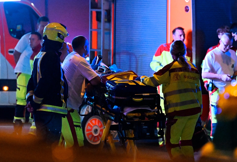 Emergency personnel and police work near the scene where one person was killed and around 15 injured after a car is believed to have hit the crowd on the outskirts of the Christopher Street Day (CSD) parade in Berlin, on July 25, 2026 (AFP/Getty)