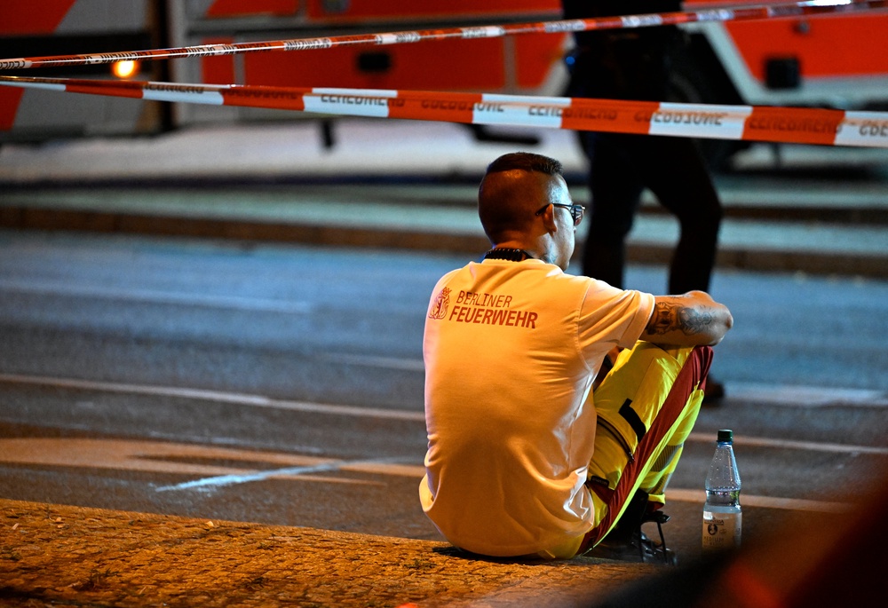 A Berlin firefighter rests near the scene where one person was killed and 16 injured after a car is believed to have hit the crowd on the outskirts of the Christopher Street Day (CSD) parade in Berlin, on 26 July 2026 (AFP/Getty)