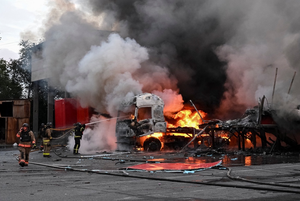 Firefighters work at the site of the postal distribution centre of Nova Post company, hit by a Russian drone strike, amid Russia's attack on Ukraine, in Zaporizhzhia, Ukraine, 25 July 2026 (Reuters)