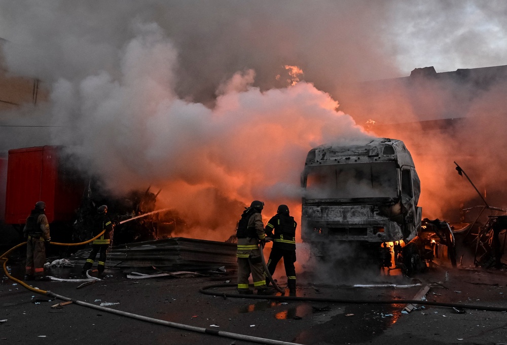 Firefighters work at the site of the postal distribution centre of Nova Post company, hit by a Russian drone strike, amid Russia's attack on Ukraine, in Zaporizhzhia, Ukraine, 25 July 2026 (Reuters)