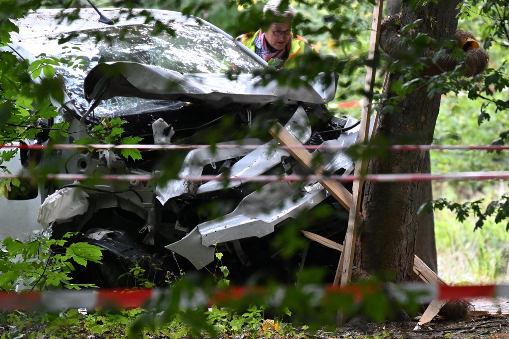 A police officer inspects a car that was allegedly driven into a crowd on the outskirts of the Christopher Street Day parade in Berlin (AFP/Getty)