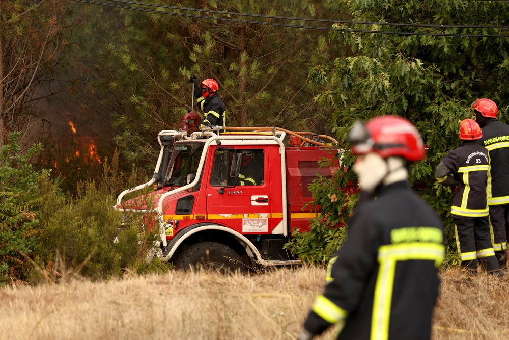 Firefighters work on the edge of a burning area in Blagon, west of Bordeaux, on July 26, 2026 as a wildfire has been ravaging the forest north of the Arcachon Basin (Gironde) since July 22 (AFP/Getty)
