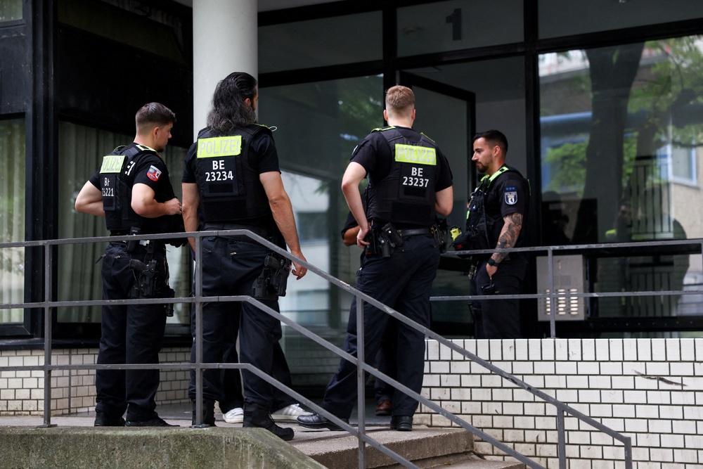 Police search the suspected attacker's apartment (Reuters)