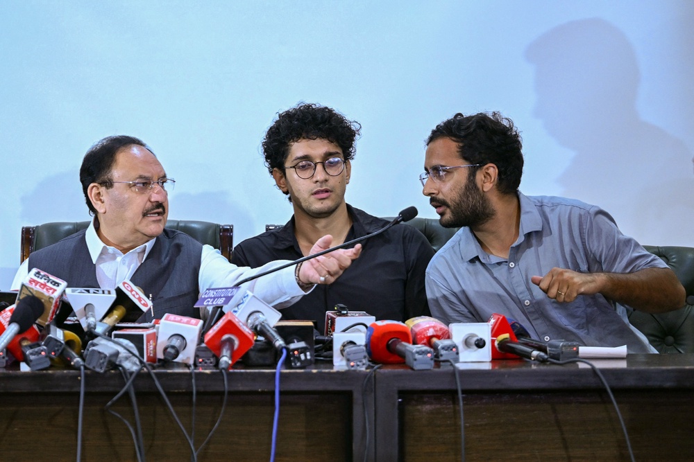 Cockroach Janta Party (CJP) spokespersons Saurav Das (C) and Ashutosh Ranka (R) along with India's Health Minister JP Nadda attend a press conference after their meeting in New Delhi on 25 July 2026 (AFP/Getty)
