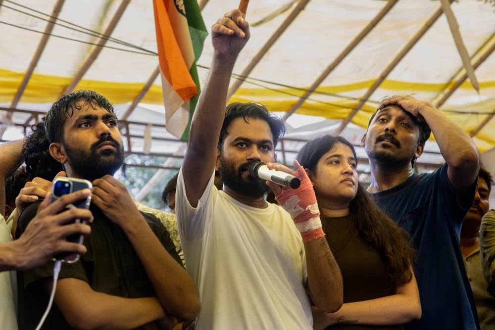 Abhijeet Dipke, founder of India's Cockroach Janta Party (CJP), addresses celebrating supporters following the resignation of Education Minister Dharmendra Pradhan, after days of protests demanding he step down over the alleged Neet examination paper leak scandal on 25 July 2026 (Getty)